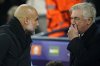Real Madrid's head coach Carlo Ancelotti, right, talks to Manchester City's head coach Pep Guardiola before the start of the Champions League playoff first leg soccer match between Manchester City and Real Madrid at the Etihad Stadium in Manchester, England, Tuesday, Feb. 11, 2025. (AP Photo/Dave Thompson)