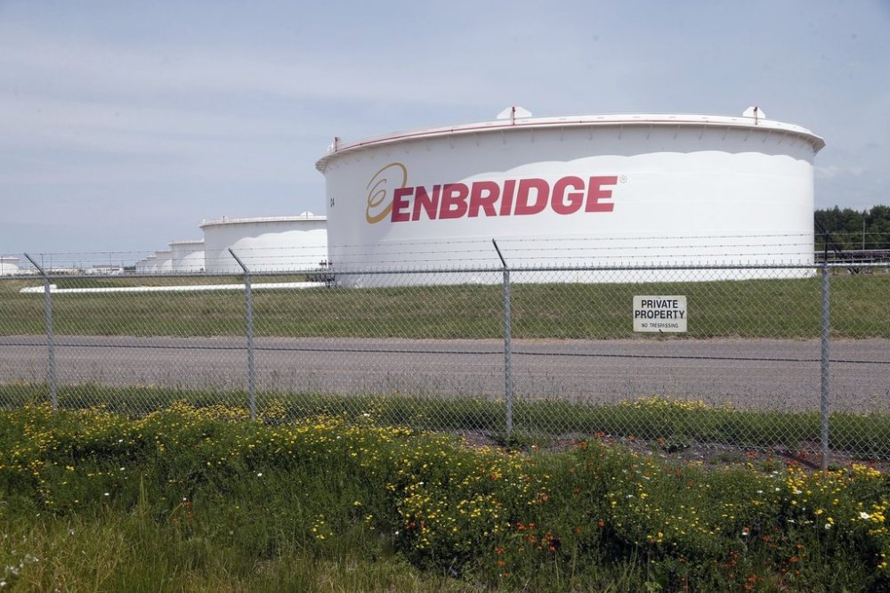 FILE - The corporate name stands out on tanks shown Friday, June 29, 2018 at at the Superior terminal of Enbridge Energy in Superior, Wis. (AP Photo/Jim Mone, File)