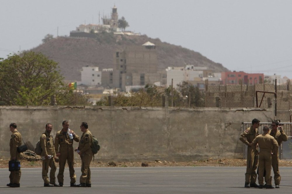 FILE - Members of a French military flight crew talk on the tarmac at France's military air base in Dakar, Senegal, Tuesday, June 2, 2009. (AP Photo/Rebecca Blackwell, File)