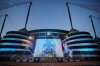 FILE - A banner celebrating their title win is illuminated outside Manchester City's Etihad stadium in Manchester, England, Saturday, May 20, 2023. (AP Photo/Jon Super, File)