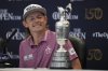 FILE - Cameron Smith, of Australia, looks at the claret jug trophy during a press conference after winning the British Open golf championship on the Old Course at St. Andrews, Scotland, Sunday July 17, 2022. (AP Photo/Alastair Grant, File)