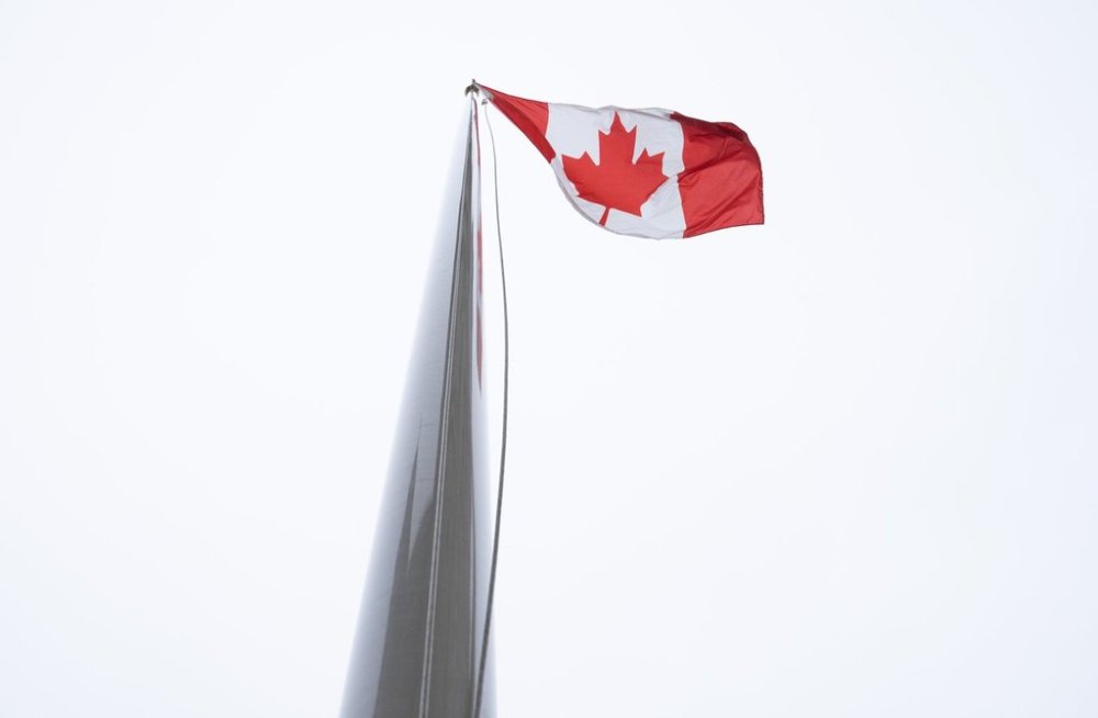 The Canadian flag flies on a flag pole outside West block in Ottawa, Wednesday, Nov. 20, 2024. THE CANADIAN PRESS/Adrian Wyld