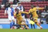 Wolverhampton Wanderers' Jean-Ricner Bellegarde and Blackburn Rovers' John Buckley, background center, vie for the ball during the English FA Cup fourth round soccer match between Blackburn Rovers and Wolverhampton Wanderers, at Ewood Park, in Blackburn, England, Sunday, Feb. 9, 2025. (Martin Rickett/PA via AP)