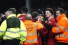 Liverpool's Curtis Jones, second from right, is separated by teammates and members of the ground staff following a clash with Everton's Abdoulaye Doucoure after the final whistle in a Premier League soccer match at Goodison Park, Wednesday, Feb. 12, 2025, in Liverpool. (Nick Potts/PA via AP)