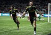 Vancouver Whitecaps' Brian White (24) celebrates his goal against Deportivo Saprissa as Ralph Priso (13) runs behind during the second half of a CONCACAF Champions Cup soccer match in Vancouver, on Thursday, February 27, 2025. THE CANADIAN PRESS/Ethan Cairns