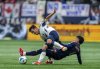 Los Angeles Galaxy's Edwin Cerrillo (6) trips Vancouver Whitecaps' Andres Cubas (20) during the first half of an MLS soccer match in Vancouver, B.C., Sunday, March 2, 2025. THE CANADIAN PRESS/Ethan Cairns