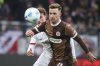 St. Pauli's Johannes Eggestein, right, and Freiburg's Patrick Osterhage, left, challenge for the ball during the German Bundesliga soccer match between FC St. Pauli and SC Freiburg in Hamburg, Germany, Saturday, Feb. 15, 2025. (Christian Charisius/dpa via AP)