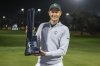 First place individual champion Adrian Meronk of Cleeks GC poses with the trophy on the 18th green after the final round of the LIV Golf tournament at Riyadh Golf Club, Saturday, Feb. 8, 2025 in Riyadh, Saudi Arabia. (Photo by Montana Pritchard/LIV Golf via AP)