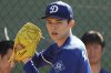 Los Angeles Dodgers pitcher Roki Sasaki (11) throws during his first live bullpen session during spring training baseball practice, Wednesday, Feb. 19, 2025, in Phoenix. (AP Photo/Darryl Webb)