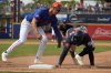 Houston Astros' Christian Walker, right, dives safely back to first ahead of the tag from New York Mets first baseman Jared Young during the fourth inning of a spring training baseball game Thursday, Feb. 27, 2025, in Port St. Lucie, Fla. (AP Photo/Jeff Roberson)