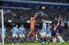 Manchester City's goalkeeper Ederson punches the ball away during the English Premier League soccer match between Manchester City and Newcastle United at Etihad stadium in Manchester, England, Saturday, Feb. 15, 2025. (AP Photo/Ian Hodgson)