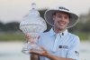 Joe Highsmith hoists his trophy after winning in the final round of the Cognizant Classic golf tournament, Sunday, March 2, 2025, in Palm Beach Gardens, Fla. (AP Photo/Rebecca Blackwell)