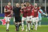 AC Milan's players argue with Referee Szymon Marciniak of Poland after he sent off AC Milan's Theo Hernandez, right, during Champions League, playoff second leg soccer match between AC Milan and Feyenoord, at the San Siro stadium in Milan, Italy, Tuesday, Feb.18, 2025. (AP Photo/Luca Bruno)