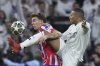Atletico Madrid's Pablo Barrios, left, fights for the ball with Real Madrid's Kylian Mbappe during the Champions League round of 16 first leg soccer match between Real Madrid and Atletico Madrid at the Bernebeu stadium in Madrid, Spain, Tuesday, March 4, 2025. (AP Photo/Manu Fernandez)