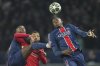 PSG's Willian Pacho, right, battles for the ball with Liverpool's Mohamed Salah during the Champions League round of 16 first leg soccer match between Paris Saint-Germain and Liverpool at the Parc des Princes in Paris, Wednesday, March 5, 2025. (AP Photo/Aurelien Morissard)