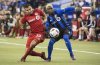 Toronto FC defender Steven Beitashour, left, battles for the ball with Montreal Impact defender Ambroise Oyongo during first half action in the first leg of the MLS Eastern Conference final at the Olympic Stadium in Montreal on November 22, 2016. THE CANADIAN PRESS/Paul Chiasson