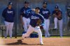 Los Angeles Dodgers two-way player Shohei Ohtani (17) works out during spring training baseball practice, Saturday, Feb. 15, 2025, in Phoenix. (AP Photo/Ashley Landis)