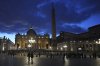 People walk at dusk in St Peter's Square at The Vatican, Thursday, Feb. 27, 2025. (AP Photo/Kirsty Wigglesworth)