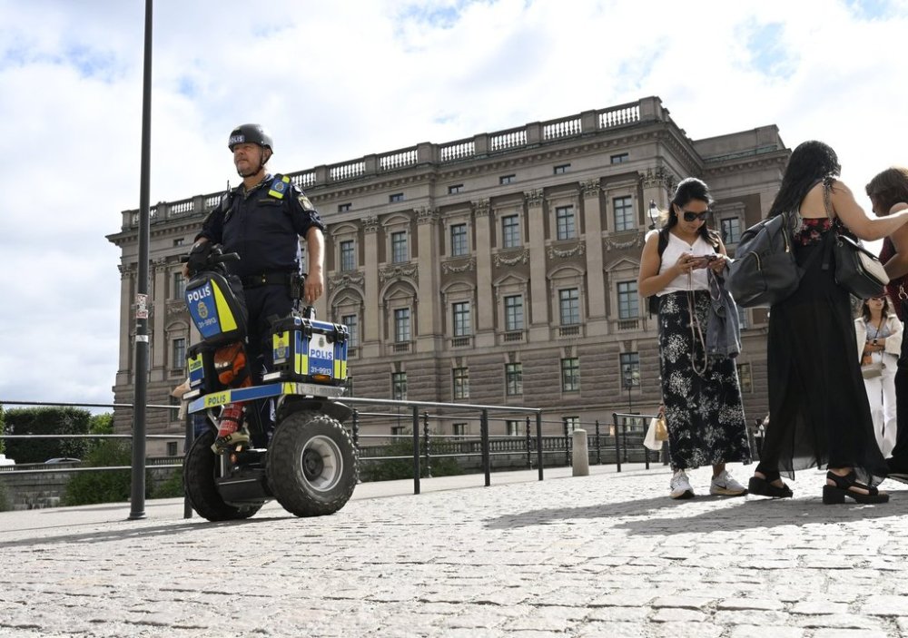 FILE - A police officer on a Segway patrols Sweden's parliament in Stockholm, Aug. 17, 2023. (Fredrik Sandberg/TT News Agency via AP, File)