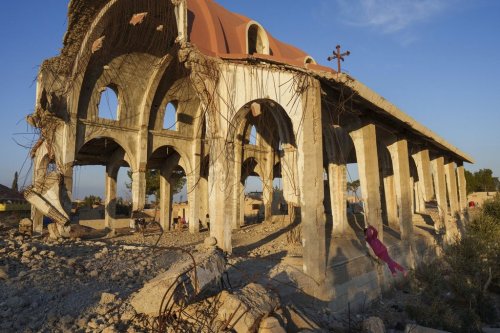 Children play in the ruins of the Church of Virgin Mary, which was destroyed by the Islamic State group in 2015, in the northeastern Syrian village of Tel Nasri, which is currently controlled by the U.S.-backed, Kurdish-led Syrian Democratic Forces, Monday, Jan. 27, 2025. (AP Photo/Bernat Armangue)