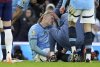 Manchester City's Erling Haaland receives treatment following an injury during the English Premier League soccer match between Manchester City and Newcastle United at Etihad stadium in Manchester, England, Saturday, Feb. 15, 2025. (Martin Rickett/PA via AP)