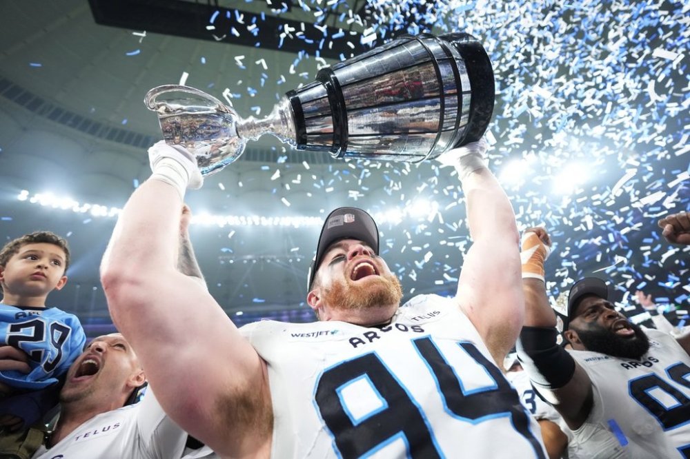 Toronto Argonauts' Jake Ceresna (94) lifts the Grey Cup after defeating the Winnipeg Blue Bombers in CFL football action at the 111th Grey Cup in Vancouver on Sunday, Nov. 17, 2024. THE CANADIAN PRESS/Nathan Denette