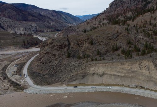 Vehicles travel on a section of Highway 8 along the Nicola River that had to be rebuilt after it was washed away during November flooding, on the Shackan Indian Band, northwest of Merritt, B.C., on March 24, 2022. THE CANADIAN PRESS/Darryl Dyck