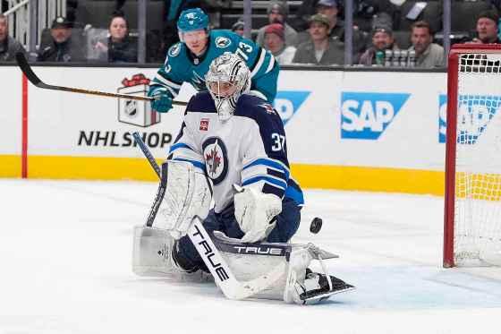 Winnipeg Jets goaltender Connor Hellebuyck (37) blocks a shot at goal against the San Jose Sharks during the Dec. 17, 2024 game in San Jose, Calif. (Tony Avelar / The Associated Press files)