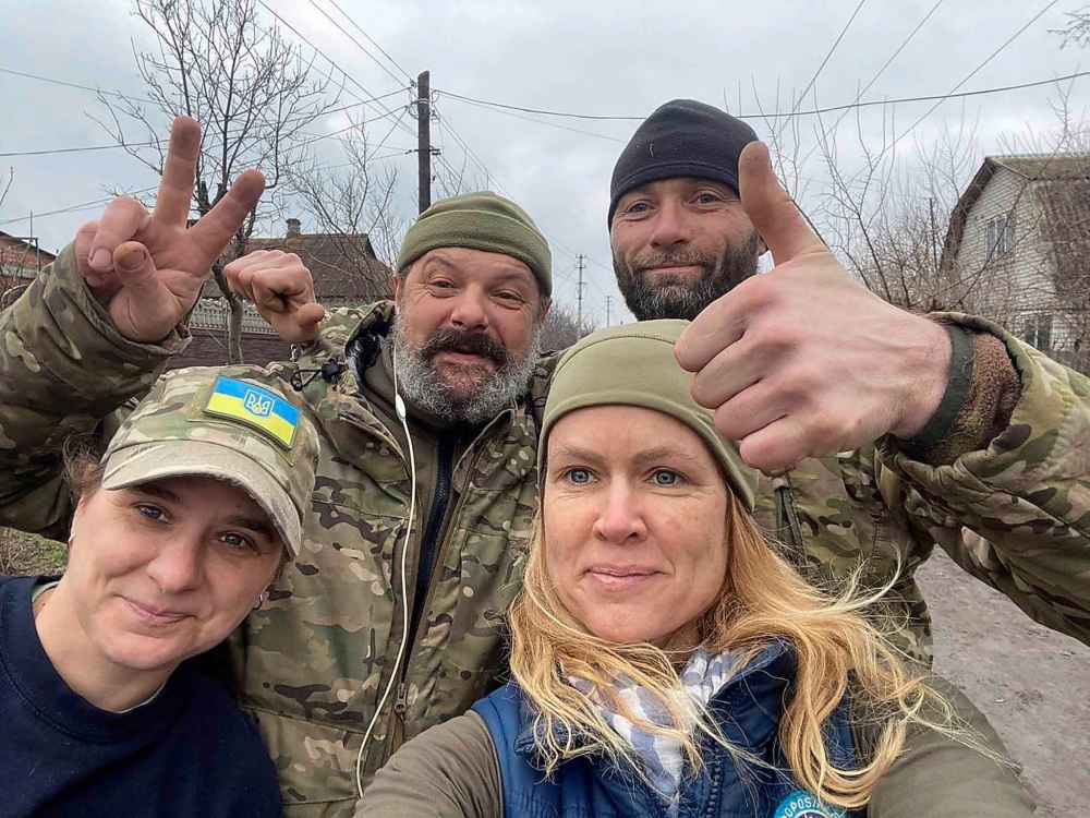 Lana Niland (bottom right) is from Saskatoon but has lived in Kyiv since 2003. She launched the group Ukrainian Patriot and is seen in this handout photo with Ukrainian military officials. THE CANADIAN PRESS/HO