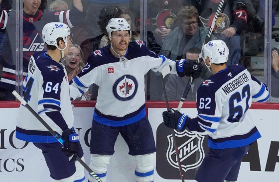 Mason Appleton (centre) celebrates his goal against the Senators with Logan Stanley (left) and Nino Niederreiter during the first period Wednesday in Ottawa. (Adrian Wyld / The Canadian Press)