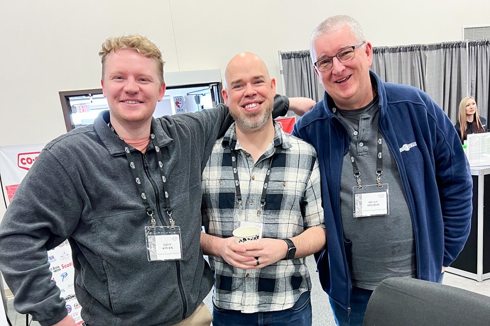 Employees at Arctic Co-operatives Limited attend a trade show together.