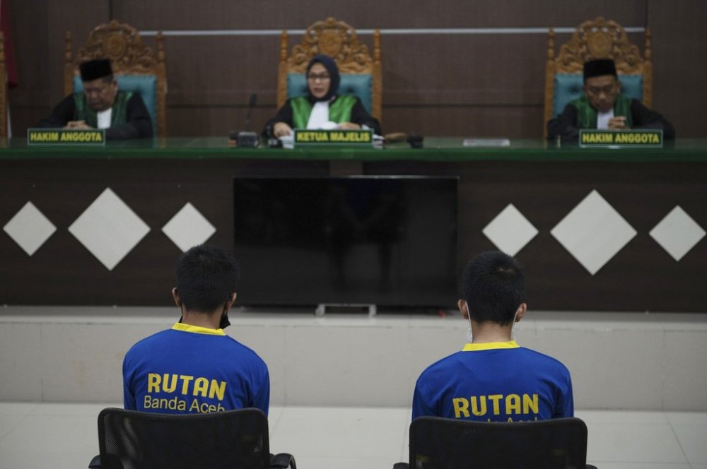Two gay men sit inside a courtroom during their trial at Sharia court in Banda Aceh, Indonesia, Monday, Feb 24, 2025. (AP Photo/ Reza Saifullah)