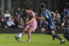 Inter Miami forward Lionel Messi (10) passes, defended by Sporting Kansas City midfielder Jacob Bartlett (16) during the first half of a CONCACAF Champions Cup soccer match, Tuesday, Feb. 25, 2025, in Fort Lauderdale, Fla. (AP Photo/Rebecca Blackwell)