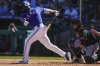 Texas Rangers' Adolis Garcia strikes out as San Francisco Giants catcher Sam Huff catches the ball in the fourth inning during a spring training baseball game Saturday, Feb. 22, 2025, in Surprise, Ariz. (AP Photo/Lindsey Wasson)