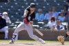 FILE - Chicago White Sox's Andrew Benintendi checks his swing during the first inning of a spring training baseball game against the Colorado Rockies, Tuesday, Feb. 25, 2025, in Scottsdale, Ariz. (AP Photo/Ross D. Franklin, File)
