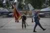 FILE - Ukraine's President Volodymyr Zelenskyy hands over the flag of a military unit on the occasion of the Air Forces Day against the background of Ukraine's Air Force's F-16 fighter jets in an undisclosed location in Ukraine, on Aug. 4, 2024. (AP Photo/Efrem Lukatsky, File)