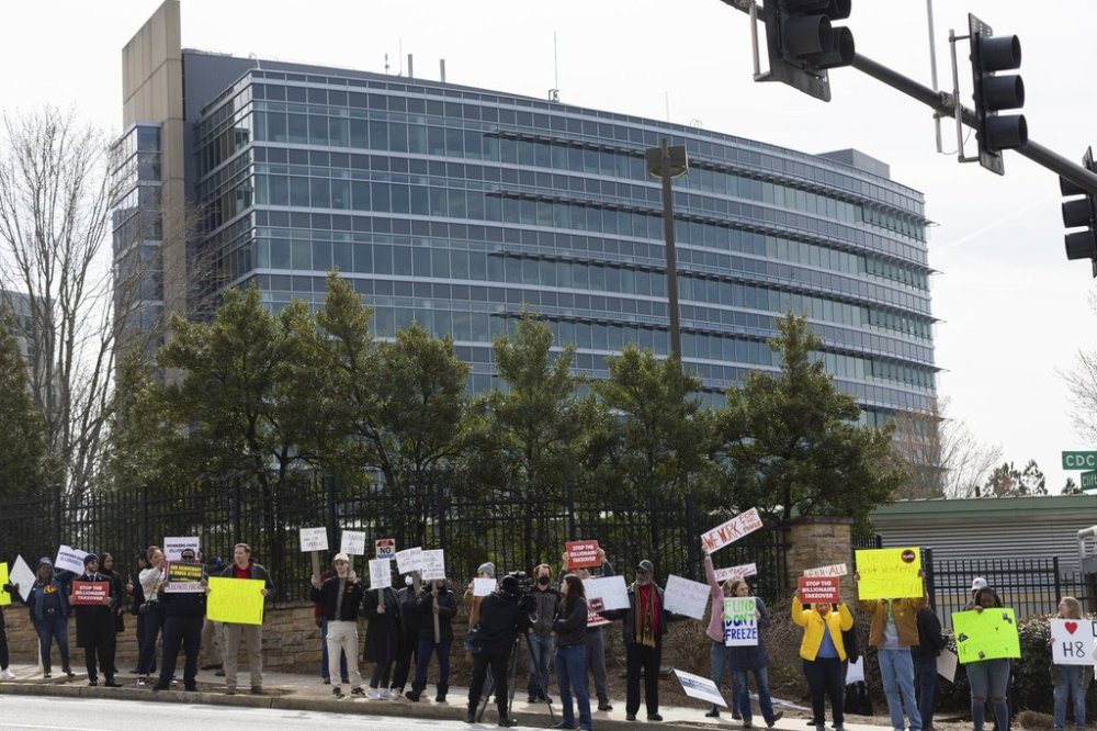 FILE - Demonstrators protest Centers for Disease Control and Prevention (CDC) layoffs in front of the CDC headquarters in Atlanta, Feb. 18, 2025. (Arvin Temkar/Atlanta Journal-Constitution via AP, File)