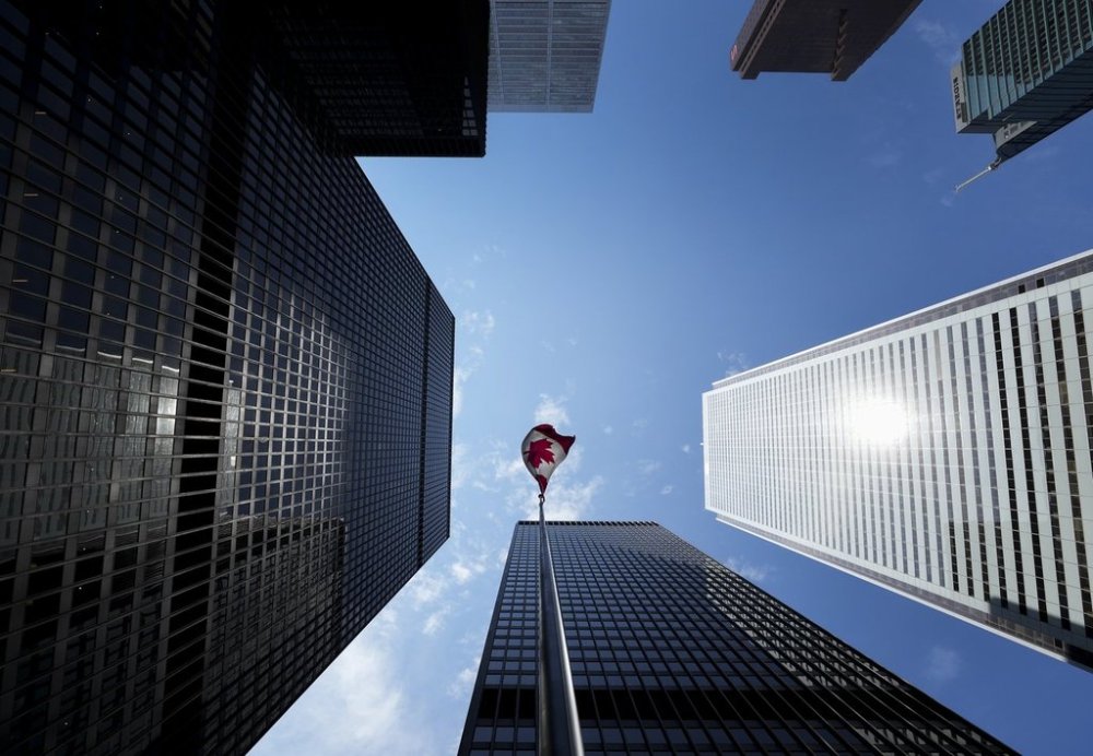 A Canadian flag flies in the Bay Street financial district in Toronto on Friday, August 5, 2022. THE CANADIAN PRESS/Nathan Denette