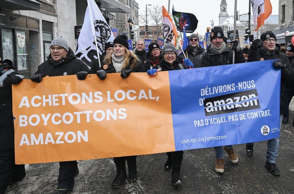 People take part in a protest in Montreal, Saturday, Feb. 15, 2025, against Amazon's decision to shutter its seven warehouses in Quebec, including what was Canada's only unionized Amazon facility. THE CANADIAN PRESS/Graham Hughes