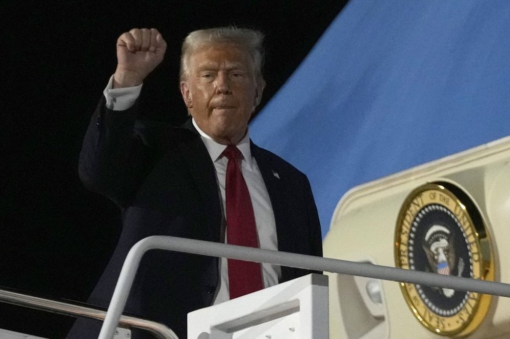 President Donald Trump gestures as he boards Air Force 1 at the Naval Air Station Joint Reserve Base in New Orleans, Sunday, Feb. 9, 2025. THE CANADIAN PRESS/AP/Ben Curtis