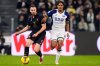 Juventus' Federico Gatti, left, and Verona's Ami Sarr, right, challenge for the ball during the Serie A soccer match between Juventus FC and Hellas Verona in Turin, Italy, Monday, March 3, 2025. (Fabio Ferrari/LaPresse via AP)