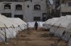 FILE - A man walks between tents for displaced Palestinians next to destroyed buildings following the Israeli air and ground offensive in Jabaliya, Gaza Strip, Thursday, Feb. 6, 2025. (AP Photo/Abdel Kareem Hana, file)