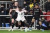 Toronto FC midfielder Richie Laryea, center, battles for the ball against D.C. United defender David Schnegg, left, and midfielder Gabriel Pirani (10) during the second half of an MLS soccer match, Saturday, Feb. 22, 2025, in Washington. (AP Photo/Nick Wass)