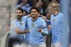 Manchester City's Omar Marmoush, centre, celebrates with team-mates after scoring their side's third goal of the game completing a hat-trick during the Premier League match between Manchester City and Newcastle at the Etihad Stadium, Manchester, England, Saturday Feb. 15, 2025. (Martin Rickett/PA via AP)
