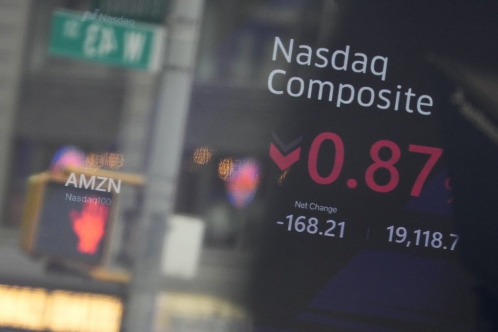 Signage in Times Square is reflected in the windows of the Nasdaq MarketSite in New York, Tuesday, Feb. 25, 2025. (AP Photo/Seth Wenig)