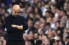 Manchester City's head coach Pep Guardiola grimaces during the Champions League playoff second leg soccer match between Real Madrid and Manchester City at the Santiago Bernabeu Stadium in Madrid, Spain, Wednesday, Feb. 19, 2025. (AP Photo/Manu Fernandez)
