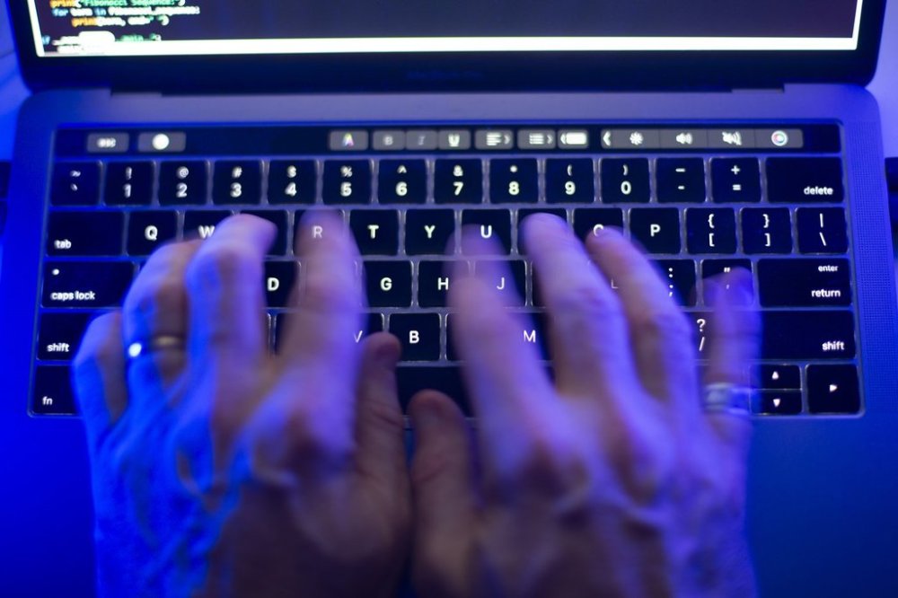 A man uses a computer keyboard in Toronto, Monday, Oct. 9, 2023 in this photo illustration. THE CANADIAN PRESS/Graeme Roy