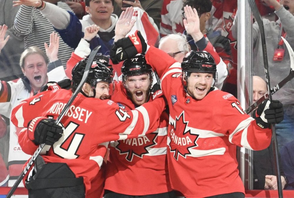 Canada's Connor McDavid (97) celebrates with teammates Josh Morrissey (44) and Sam Reinhart (13) after scoring against the United States during first period 4 Nations Face-Off hockey action in Montreal on February 15, 2025. THE CANADIAN PRESS/Graham Hughes