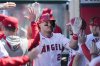 FILE - Los Angeles Angels designated hitter Mike Trout celebrates in the dugout after hitting a home run during the sixth inning of a baseball game against the Baltimore Orioles in Anaheim, Calif., April 24, 2024. (AP Photo/Ashley Landis, File)