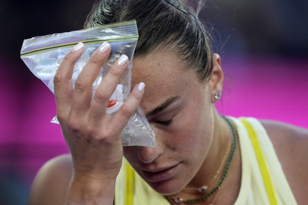 Aryna Sabalenka of Belarus places a bag of ice to her face during the women's singles final against Madison Keys of the U.S. at the Australian Open tennis championship in Melbourne, Australia, Saturday, Jan. 25, 2025. (AP Photo/Ng Han Guan)